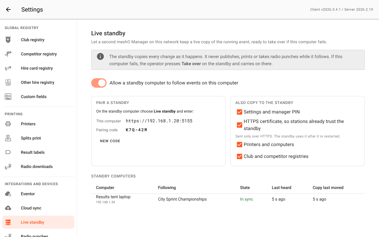 Settings → Live standby on the main computer: the switch that allows a standby, the Pair a standby box with this computer's address and pairing code and a New code button, the Also copy to the standby choices, and the Standby computers table listing one standby that is in sync.
